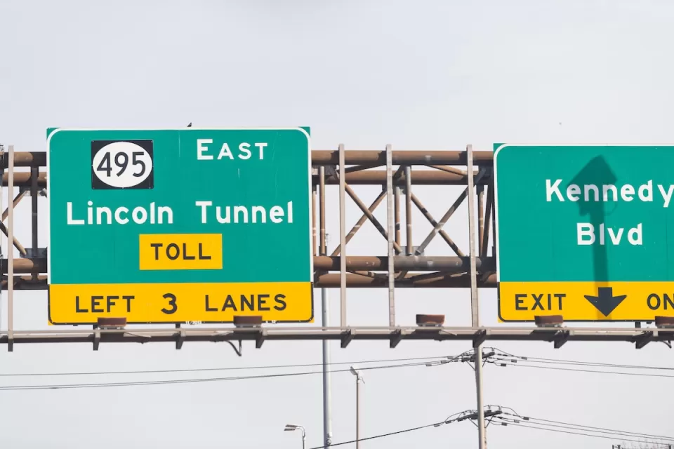 Close-up of green freeway sign for Lincoln Tunnel in New Jersey.